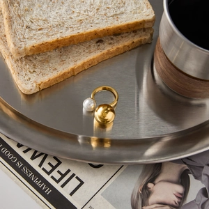 Chic open ring with white pearl and gold bead on a stylish metal display tray