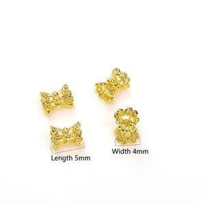 Quattro perline distanziali dorate a forma di fiocco 5mm x 4mm per gioielli