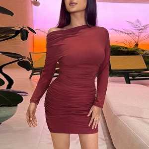 Detailed view of the side shirring and ruched fabric on this burgundy bodycon dress