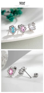 Detail view of geometric zircon stud earrings with screw backs in blue, pink, and white