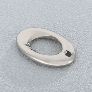 Macro detail of polished stainless steel oval pendant connector for DIY jewelry