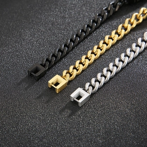 Close-up of titanium steel Cuban link bracelets in black, gold, and silver finishes