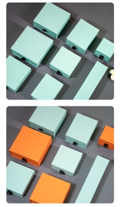 Detail view of drawer jewelry boxes in mint green and orange with silk handles