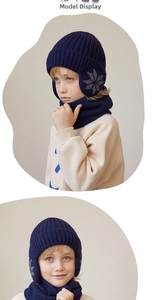 Detail of kids winter knit hat and scarf set in navy blue with snowflake embroidery