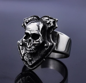 Macro shot of vintage silver skull shield ring with oxidized punk biker design details