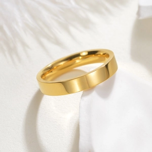 Polished 18k gold plated stainless steel band ring shown from a 45-degree side angle view