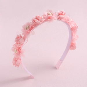 Detail of pink floral headband featuring faux roses, lace mesh, and delicate beadwork
