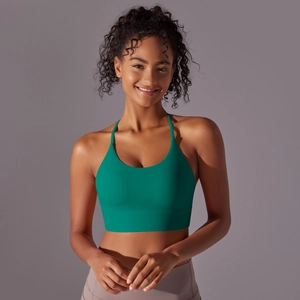 Detail of teal cross-back sports bra with supportive wide band and soft nylon fabric