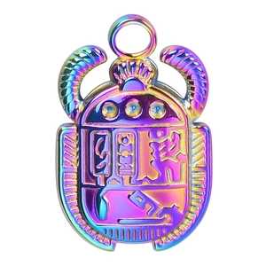 Macro detail of Egyptian scarab beetle pendant with iridescent vacuum 18k gold plating