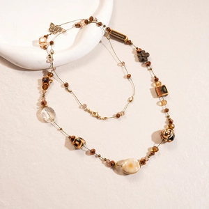 Vintage beaded necklace with brown ceramic beads and gold butterfly pendant