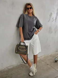 Detail of grey washed cotton T-shirt featuring a drop shoulder and oversized retro fit