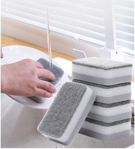 Close-up of double-sided cleaning sponges showing the grey scouring pad and white foam