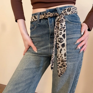 Leopard print chiffon scarf styled as a belt on high-waist jeans for a chic look