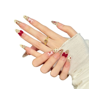 Long almond press-on nails with red velvet bows and white bunny art for New Year