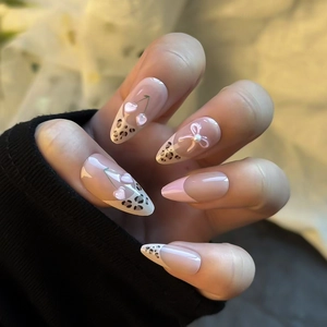 Press on nails with almond shape, leopard french tips and 3D cherry heart accents