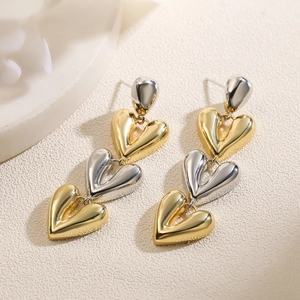 Minimalist gold and silver heart drop earrings with three dangling linked metal hearts