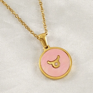 Detailed macro view of 18K gold plated Taurus constellation pendant with pink inlay