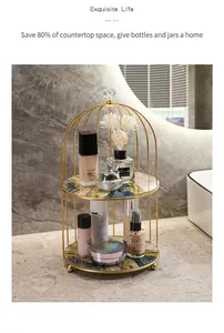 Detail of double-tier birdcage makeup organizer with gold metal frame and marble shelves