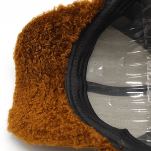 Detail of warm brown faux shearling texture on baseball cap with soft mesh lining