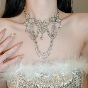 Close-up of silver multilayer fringe necklace with rhinestones and geometric design