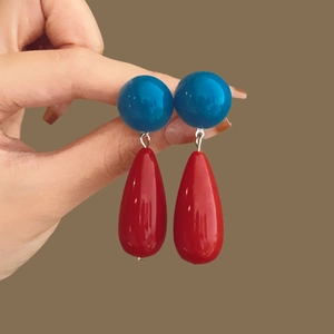 Minimalist red resin teardrop earrings with blue spherical accents in retro pop style