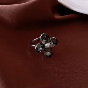 Macro shot of a floral ring with dark faceted crystals and silver petal textures
