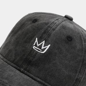 Vintage washed cotton baseball cap featuring crown embroidery with a classic distressed texture