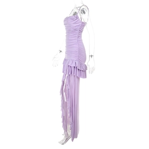 Detail view of purple ruched slim fit dress featuring layered ruffled hem and side slit