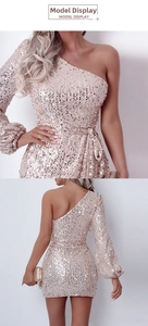 Close-up of champagne sequin dress with one-shoulder design and shimmering texture details