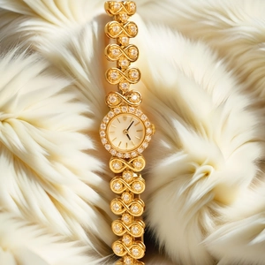 Macro detail of luxury gold jewelry watch with sparkling stones on soft white fur