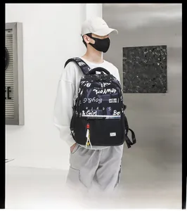 Side view of black graffiti backpack with reflective strips and multi-pocket design