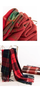 Close-up of soft red and green plaid cashmere scarf with delicate tassel detail