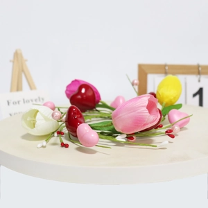 Detail of tulip candle ring with pink hearts, berries and faux green leaves on white stand