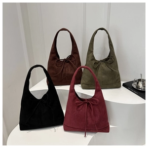 Close-up of four suede tote bags in black, dark coffee, olive green, and burgundy colors