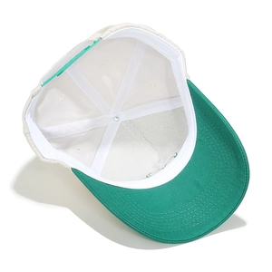 Detailed interior of two-tone baseball cap with green plastic buckle and white sweatband