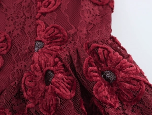 Detail of dark red lace dress with 3D velvet flower appliques and shiny sequins decoration