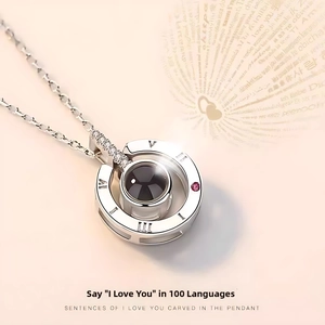Detail showing Roman numerals and 100 languages love projection stone on silver necklace