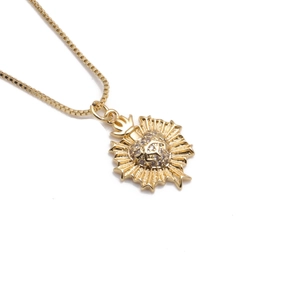 Golden Sacred Heart necklace with crown pendant and clear gemstones on box chain
