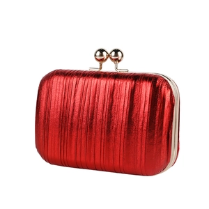 Metallic red pleated evening clutch bag with golden double sphere clasp on white background