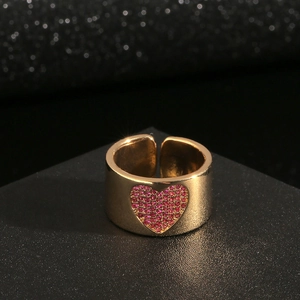 Minimalist 18K gold wide open ring with pink heart zircon on a black display stand