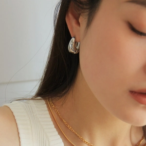 Stylish silver teardrop hoop earrings for women, featuring a smooth metallic finish for daily wear