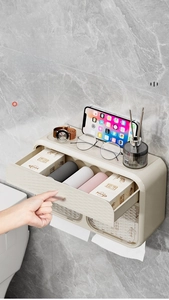 Detail of wall-mounted bathroom tissue box with storage shelf and privacy drawer