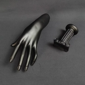 Top view of matte black mannequin hand display with matching Roman column stand