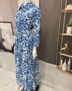Detailed view of long-sleeve maxi dress with blue tile print and matching waist tie belt
