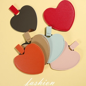 Irregular heart-shaped portable makeup mirrors in various colorful PU leather cases