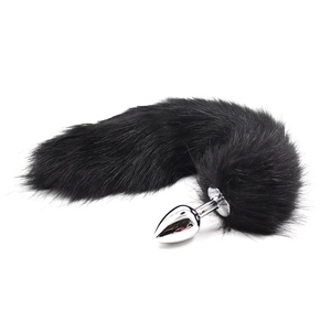 Detail of a black plush fox tail accessory with a smooth stainless steel metal plug