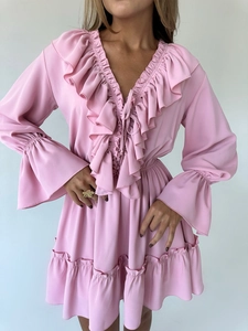 Close-up of pink V-neck dress with layered ruffles, lace-up detail and bell sleeves