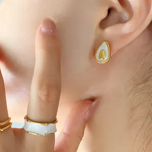 Minimalist avocado-shaped jewelry set with white enamel earrings and gold ring on model