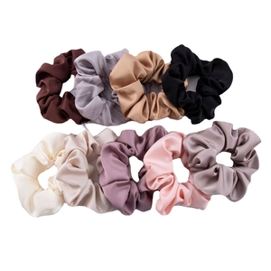 Set of nine silk satin scrunchies in neutral earth tones on a clean white background