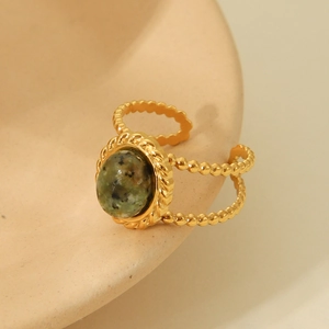 Detail of vintage gold open ring featuring an oval green marble natural stone inlay